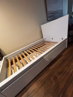 Twin size bed frame with built-in storage drawers and headboard