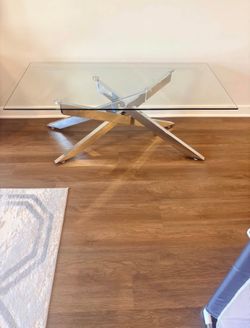 Brand new glass coffee table with deco silver legs