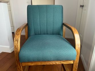 Two upholstered teal chairs,m