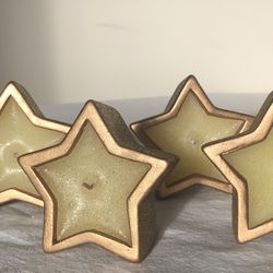 Twelve 7 oz. Holiday Inspirations Star Shape Terra Cotta Pot Candle.