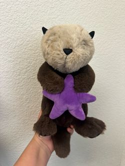 Otter plush with purple starfish