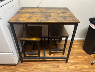 Wooden table with two stools