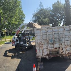 Bobcat With Heavy Duty Breaker Roll Off Dumpsters 