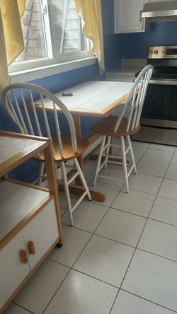 Tile top kitchen table two chairs and a cart