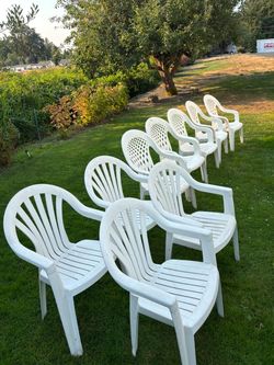 9 white resin chairs