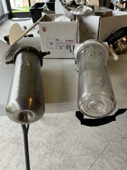 two water filters, good shape, one stainless steel and solid brass