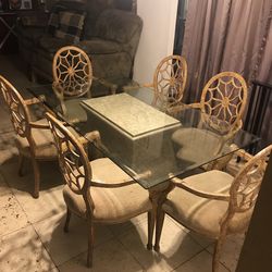 Glass top table with base and four chairs