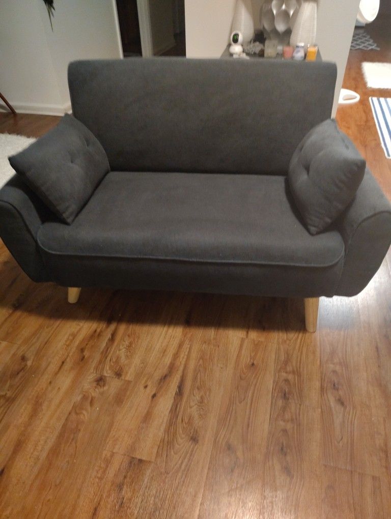 A CUTE LITTLE BLUE COMFORTABLE SOFA