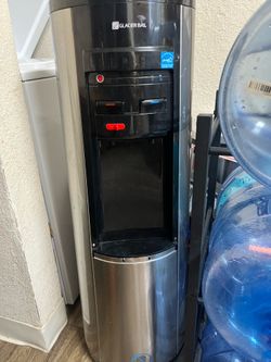Glacier Bay hot and cold water cooler dispenser with water bottle rack