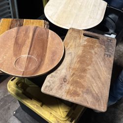 Lot of 4 wooden pizza peels and serving boards used in a commercial setting