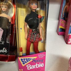 1995 Special Edition School Spirit Barbie Doll by Mattel. The doll has blonde hair, blue eyes, and is ready for the first day of class.  It comes dres