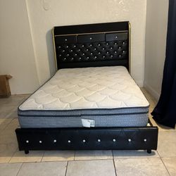 a bed frame with an upholstered headboard and a mattress.