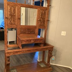 Antique hand carved hall tree with beveled mirror
