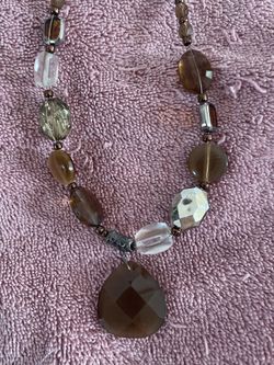 Multi beaded necklace with brown tones.