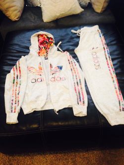 Adidas pent with jacket. This is new and white color with colorful sign. I love it but the main thing that I want to sell it is; it's very small for
