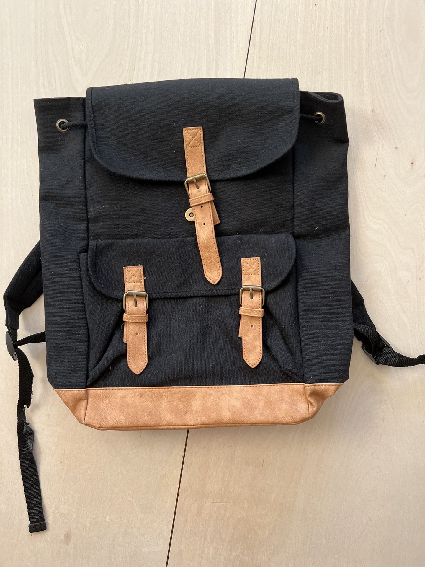 Brand New in original packaging. DSW Black And Tan Cotton Canvas Backpack