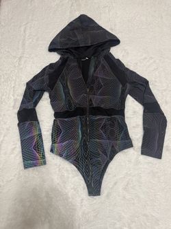 Black hooded rainbow light reflective one-piece bodysuit with zip-front closure. Iridescent geometric lpatterns New 1x light reflective rainbow body