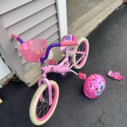 Girl bike with training wheels and helmet