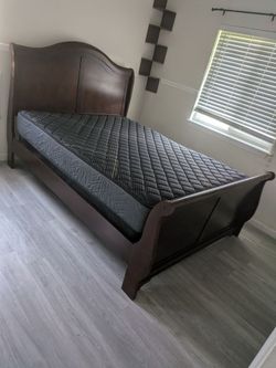 Nice wood queen bed with fairly new mattress and box springs
