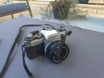 Canon AE-1 film camera with 50mm lens. Works.