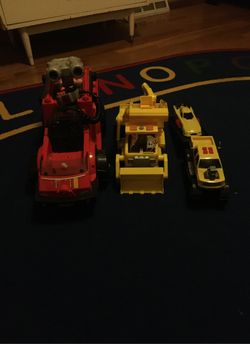 Paw patrol truck , fisher price truck, and random truck with trailer with race car