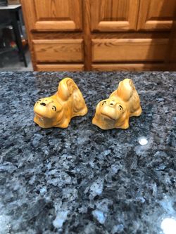 Vintage Pottery Brown Dog Figurines Pair of Salt and Pepper Shakers.  The bottom has Japan stamped on it in red.  Preowned No stoppers.  See pictures.