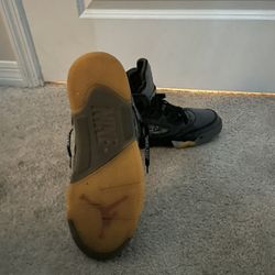 Nike Air Jordan 5 Retro SP designed in collaboration with Off-White, featuring a black textile mesh upper and "shoelace" branding. 