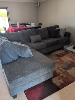 Beautiful like new sectional sofa with pillows and carpet