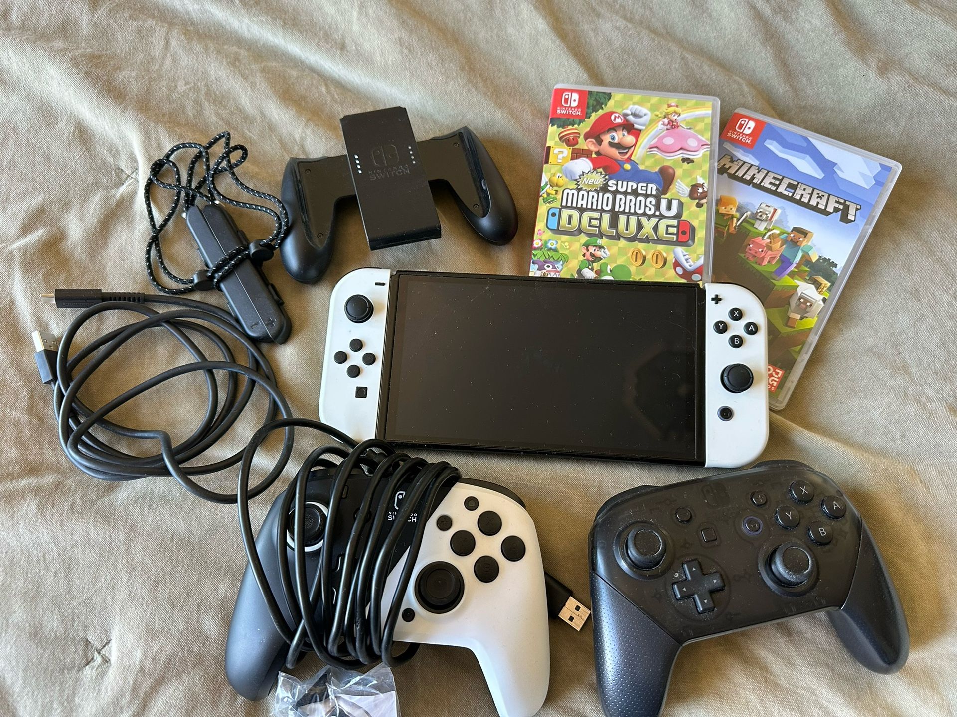 OLED Nintendo Switch with controller and games