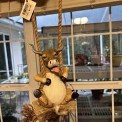 Happy Bull On A Swing