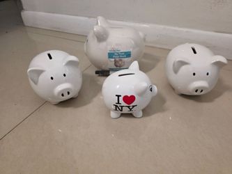 New: A set of 4 ceramic piggy banks. One measures 5 inches wide; two measure 7 inches wide; and one measures 8 inches wide