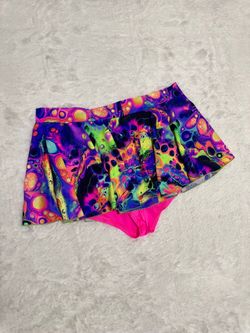 Bright multicolor psychedelic swim skirt with coordinating hot pink briefs. Soft, quick-dry fabric made for pool and beach play. Elastic waist for eas