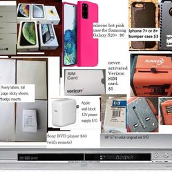 DVD player, Apple 12W wall power supply charging block, empty boxes, iphone/Samsung phone cases, Verizon Sim card, international travel adapter, webca