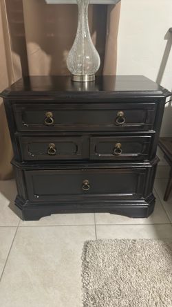 Two wooden nightstand features distinctive antique-style brass hardware.