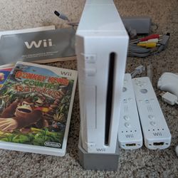 Nintendo wii console, two controllers and two nunchucks, and two incredible games