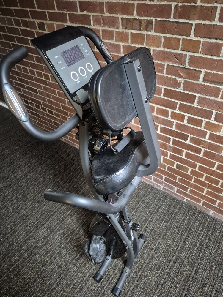 EXERCISE BIKE ADJUSTS TO DIFFERENT POSITIONS & FOLDS UP & THE MONITOR WORKS/ WIDE COMFORTABLE SEAT/ $40.00 FIRM