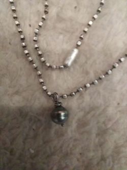 8mm genuine Tahitian biresque pearl on a sterling silver zipper chain.