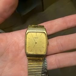 Seiko Watch And One Pound Coin, 50 Pence Coin.