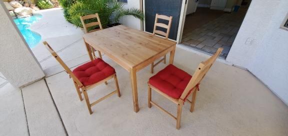 Ikea JOKKMOKK table, Brown with Red Chair cushion.