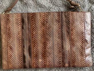 Brown clutch with straps.