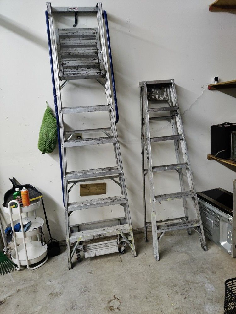Two Ladders ,One Is A Huge Platform Painters Ladder Other Is Smaller