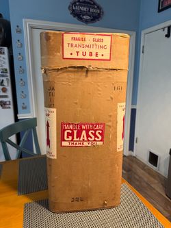Large Empty Hard Cardboard packing container originally for a glass transmitting tube. labeled 'Fragile – Glass Transmitting Tube' with 'Handle with C