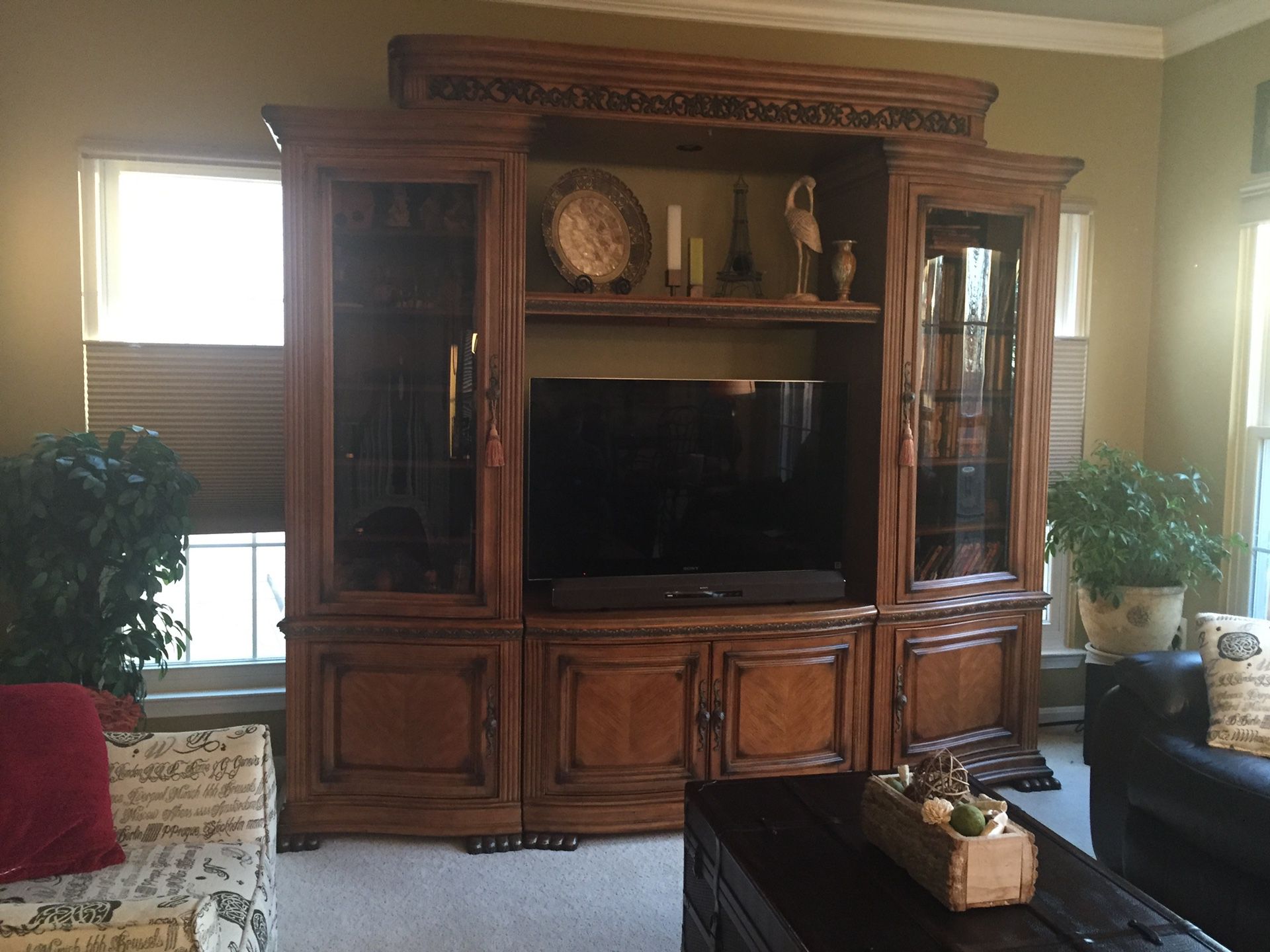 Beautiful entertainment center with curved glass cabinets. Holds a 44" television without expanding but can expand to approximately 60". Center shel