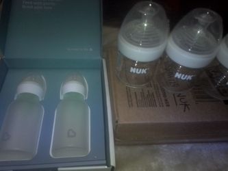 New glass baby bottles, 5 for 40, and 2 child car seats, 40 for both sets.