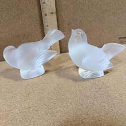 Signed vintage frosted crystal bird figurines designed by Lalique in France, specifically known as the Sparrow or Moineau figures.
