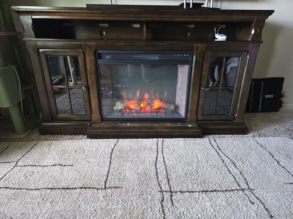 Entertainment Center With Electric Fire Place In It