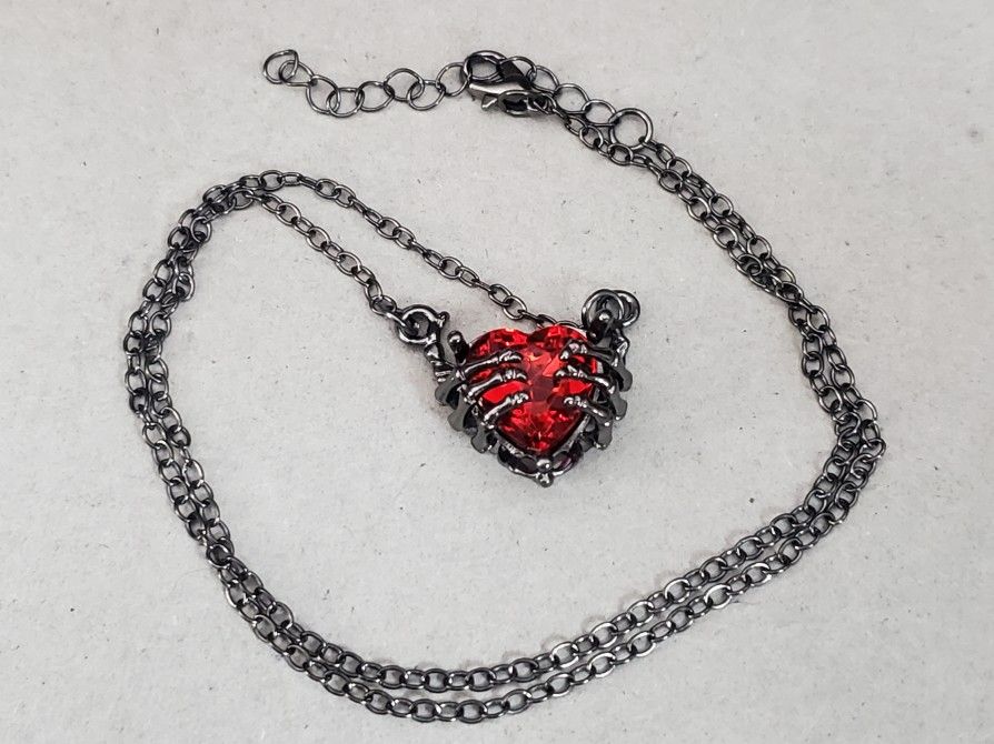 Gunmetal Grey Skeleton Hands With Bright Red Heart Goth Halloween Necklace