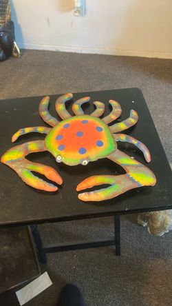 Hand painted metal crab wall decor piece.