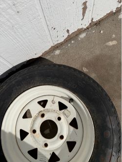 5.30-12 trailer tire is mounted on a white 5-lug steel rim.
