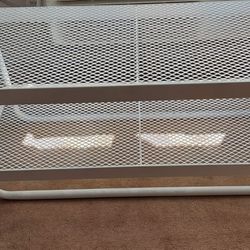 Solid metal chair with shelf for shoes.